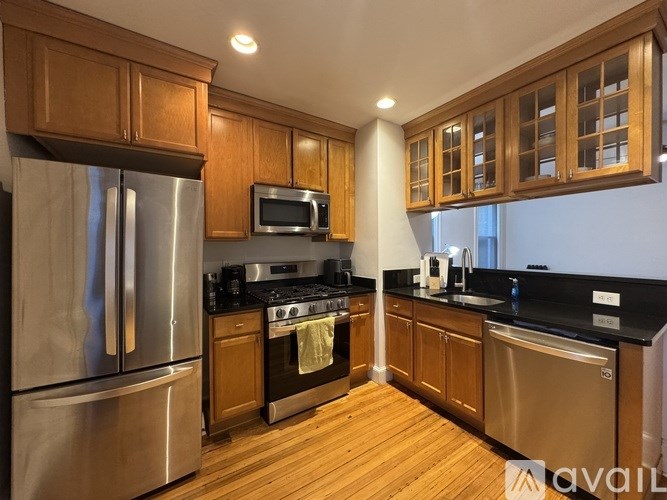 A kitchen with wooden cabinets and stainless steel appliances.