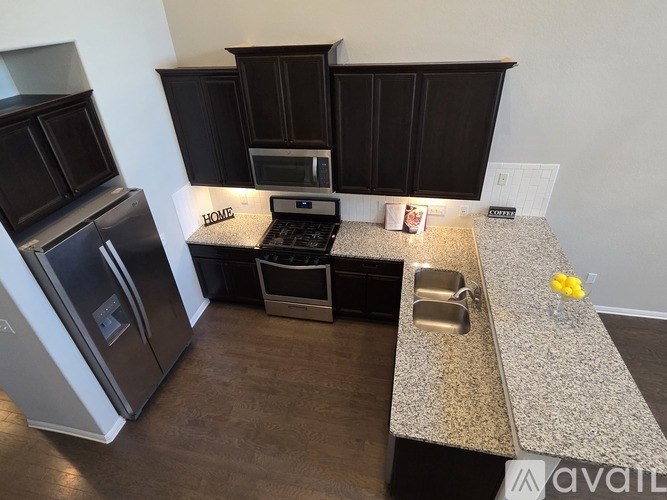 A kitchen with granite countertops and stainless steel appliances.