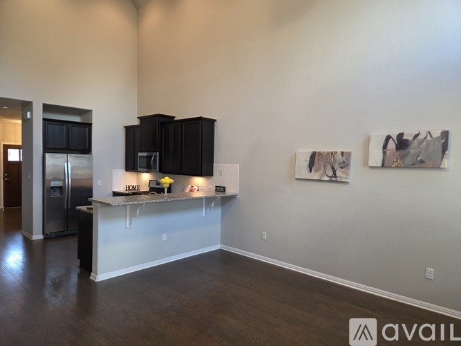A kitchen with black cabinets and a white countertop.