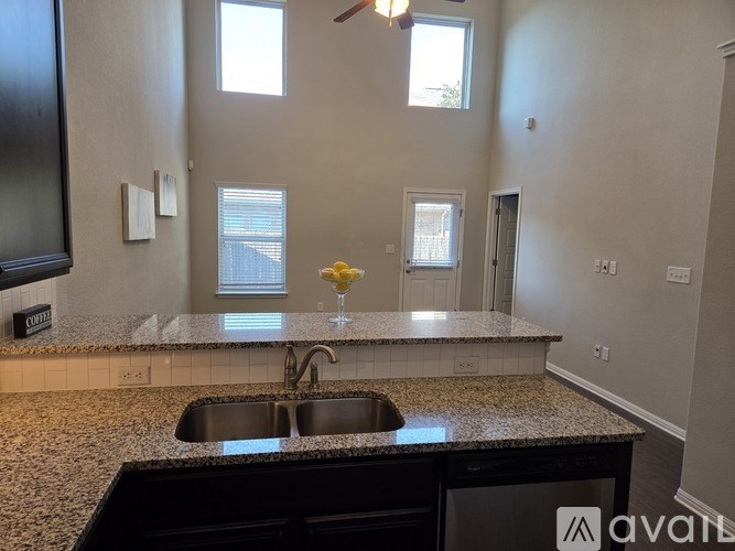 A kitchen with granite countertops and a sink.