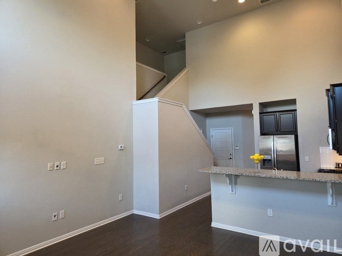 A kitchen area with a counter and a refrigerator.