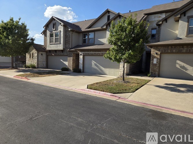 A row of houses with a street in front.