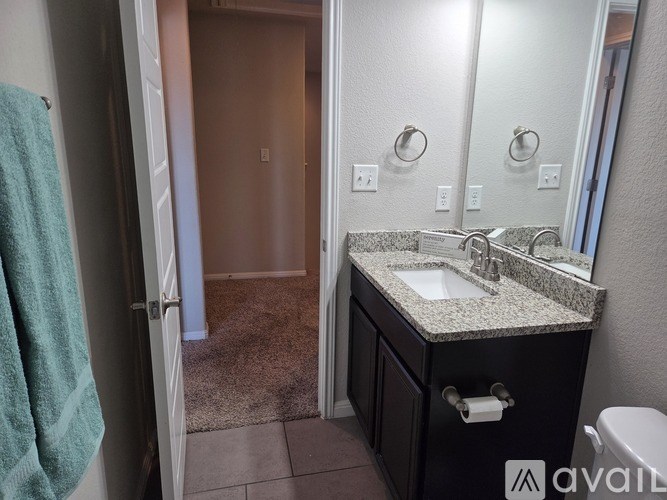 A bathroom with a sink, mirror, and toilet.