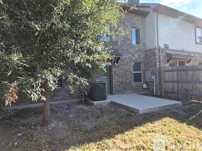 A house with a tree in front of it.