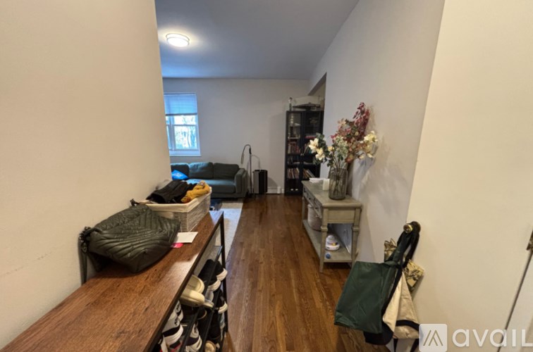 A room with a couch, a table, and a window.