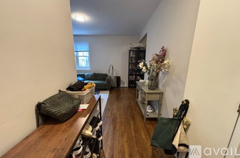 A room with a couch, a table, and a window.