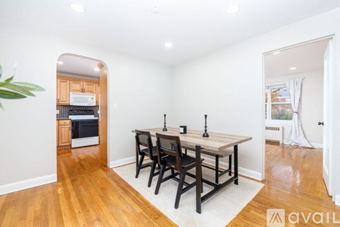 A dining room with a wooden table and chairs.