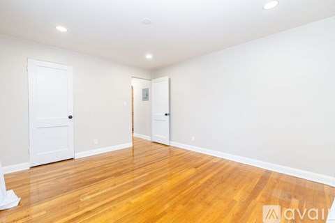 A room with wooden floors and white walls.