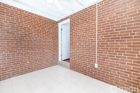 A room with a white door and a white floor.