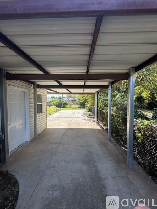 A covered walkway leads to a white door.