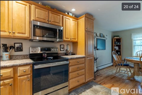 A kitchen with wooden cabinets and a black stove top oven.