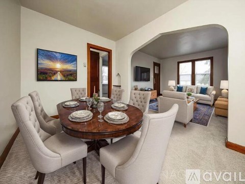 A dining room with a round table set for six.