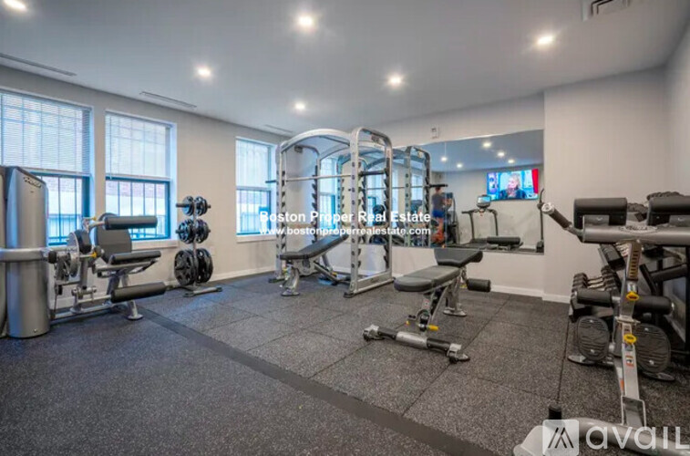 A well-equipped gym with various exercise machines and weights.
