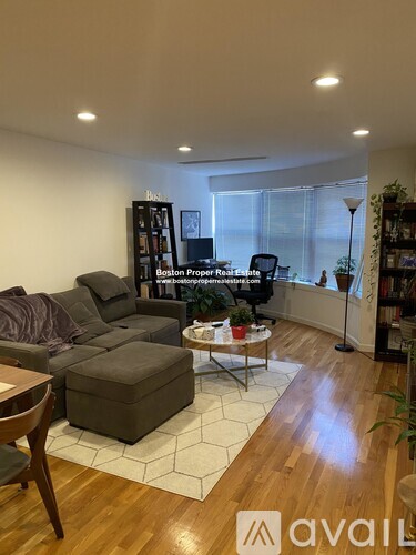 A living room with a grey sofa and a coffee table.