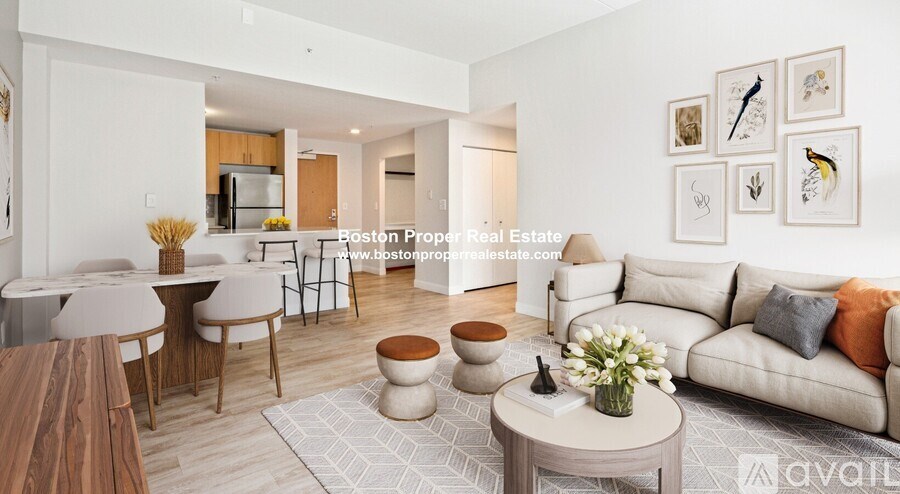 A modern living room with a dining area and a kitchen in the background.
