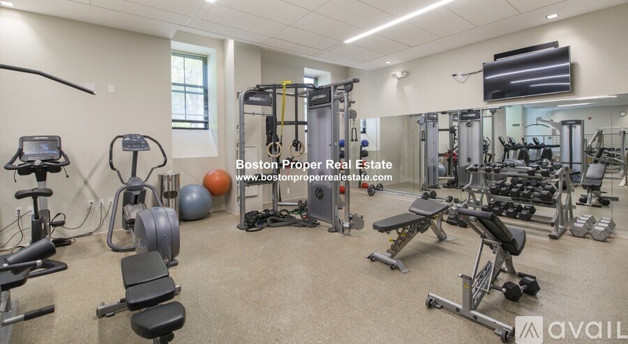 A well-equipped gym with a variety of exercise machines and weights.