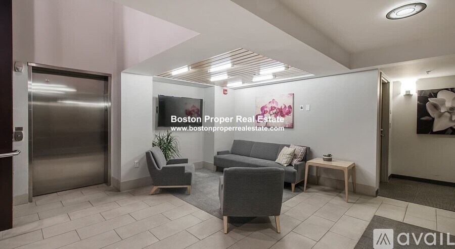 A modern waiting area with a sign for Boston Proper Real Estate.