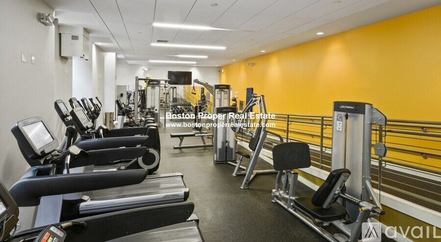 A gym with treadmills, weights, and exercise equipment.