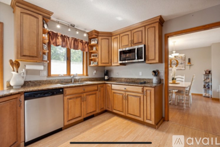 A kitchen with wooden cabinets and a dishwasher.