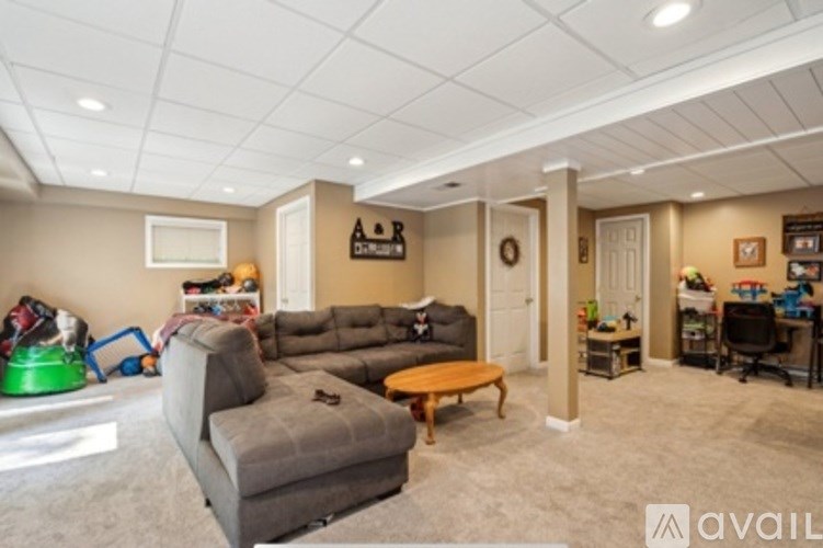 A living room with a grey couch and a coffee table.