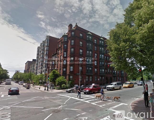 A street view of a city with cars, pedestrians and buildings.