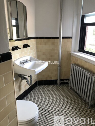 A bathroom with a white sink and a white toilet.