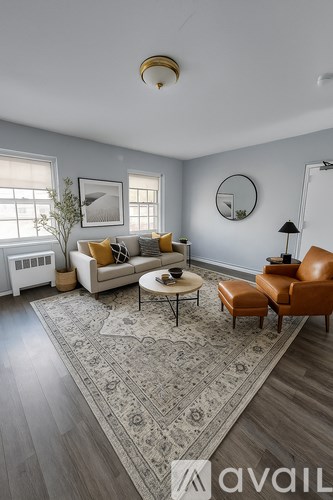 A living room with a sofa, armchair, and coffee table.