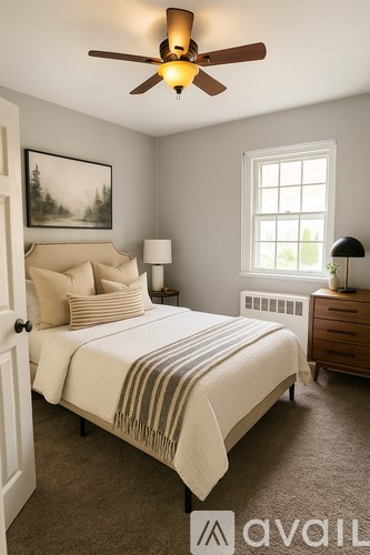 A bedroom with a bed, nightstand, and window.