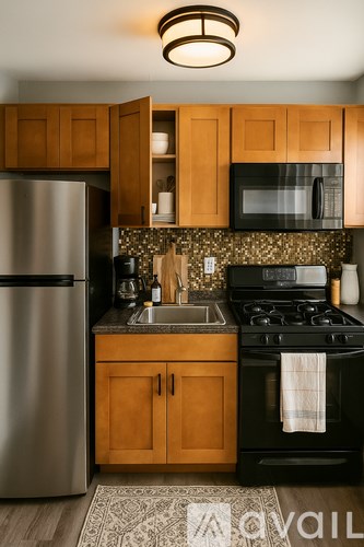 A kitchen with wooden cabinets and a black stove top oven.