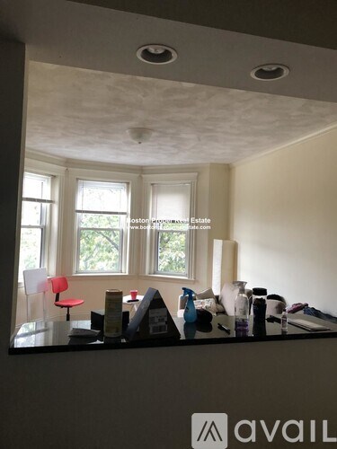 A room with a desk and a window.