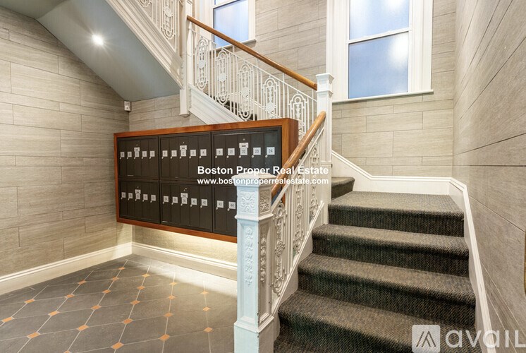 A staircase with a sign that says "Boston Proper Real Estate" on it.