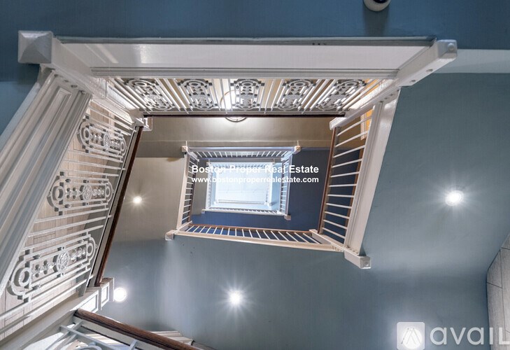 A staircase with a light on the wall.