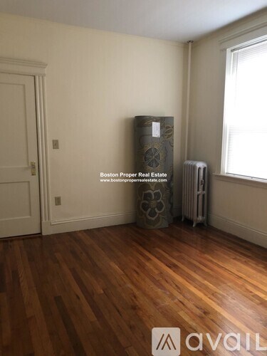 A room with wooden floors and a white door.