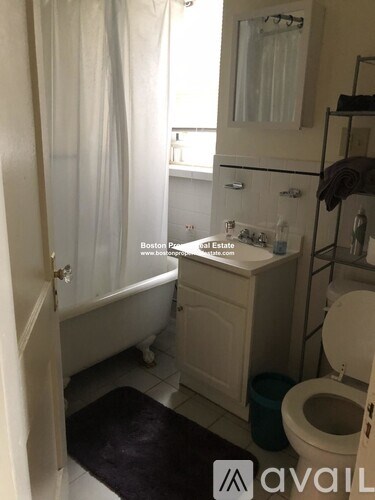 A small bathroom with a toilet, sink, and bathtub.