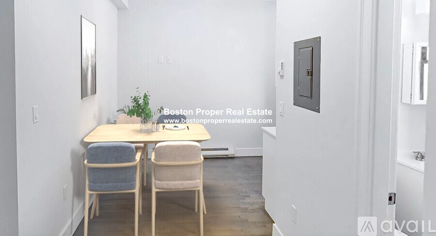 A dining room with a table and chairs.