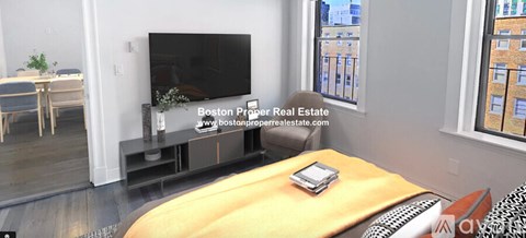A living room with a television and a table with a book on it.