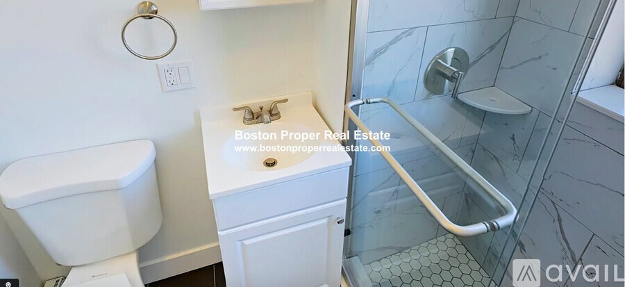 A white toilet sits next to a sink in a small bathroom.