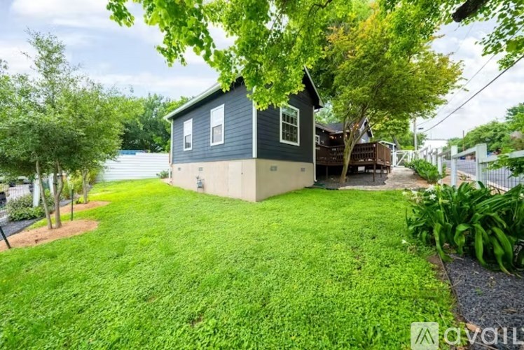 A small house with a green lawn in front.