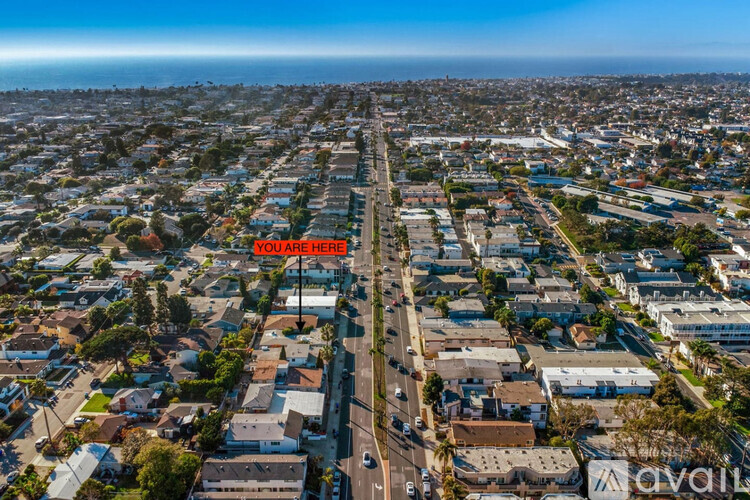 A bird's eye view of a residential area with a street running through it.