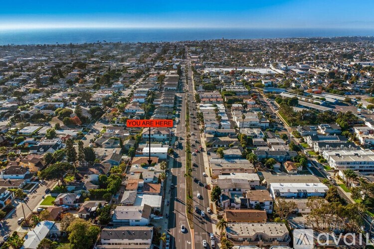 A bird's eye view of a residential area with a street running through it.