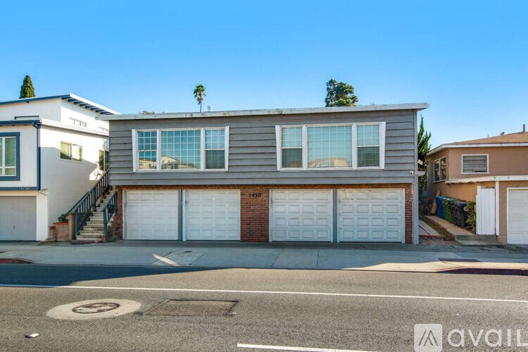 A house with a garage and a tree on the roof.