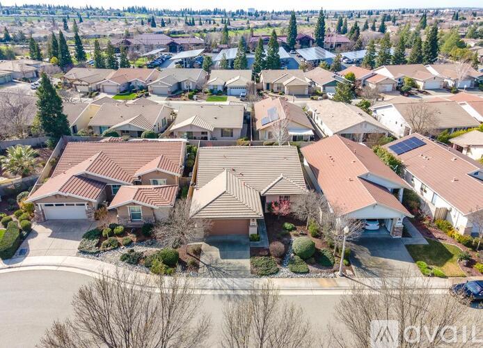 A bird's eye view of a suburban neighborhood with houses and trees.