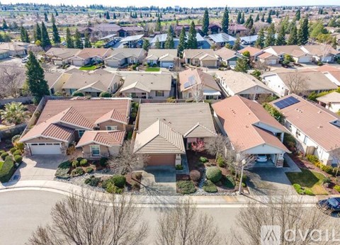 A bird's eye view of a suburban neighborhood with houses and trees.
