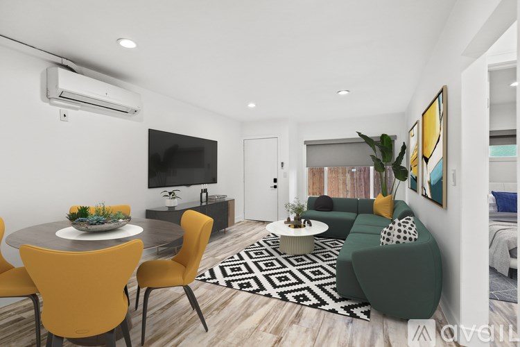 A modern living room with a grey dining table and yellow chairs.