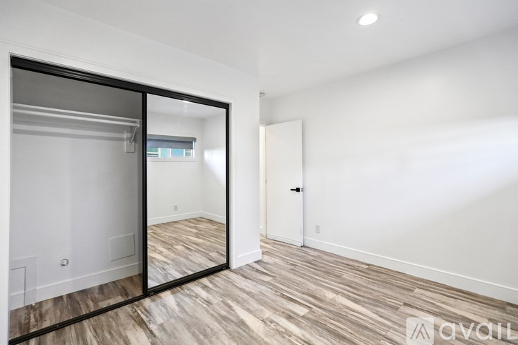 A room with a sliding door and wood flooring.
