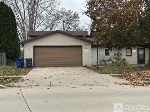 A house with a brown garage door is for sale.