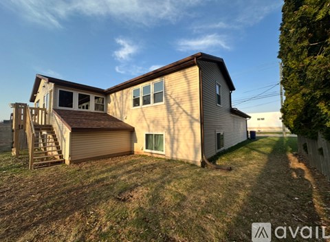 A house with a garage and a staircase leading to it.