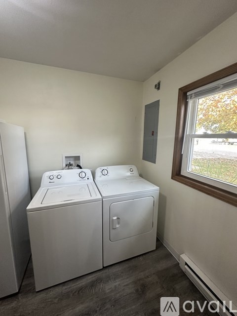 A small laundry room with a washer and dryer.