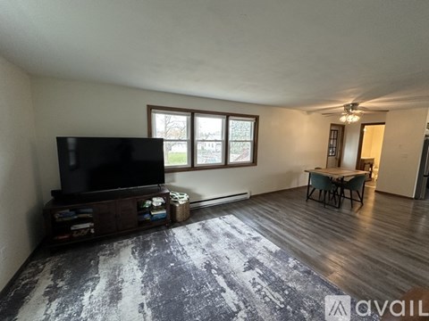 A living room with a television and a chair.