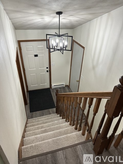 A staircase with a light hanging above it.